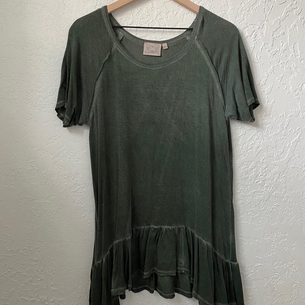 Green top. Loose fit.